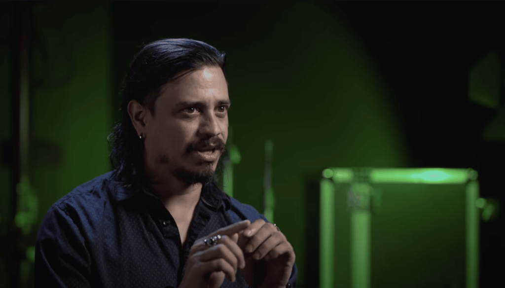 an image of Nando while he is talking with a green-lit background.