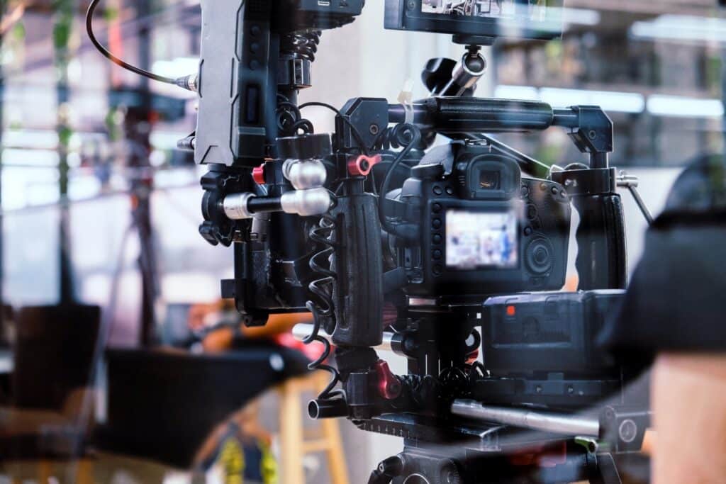 A camera being operated to film a scene in the digital media industry.