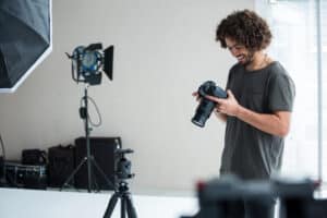 A man taking photos at a photography shoot. How to make money as a photographer.