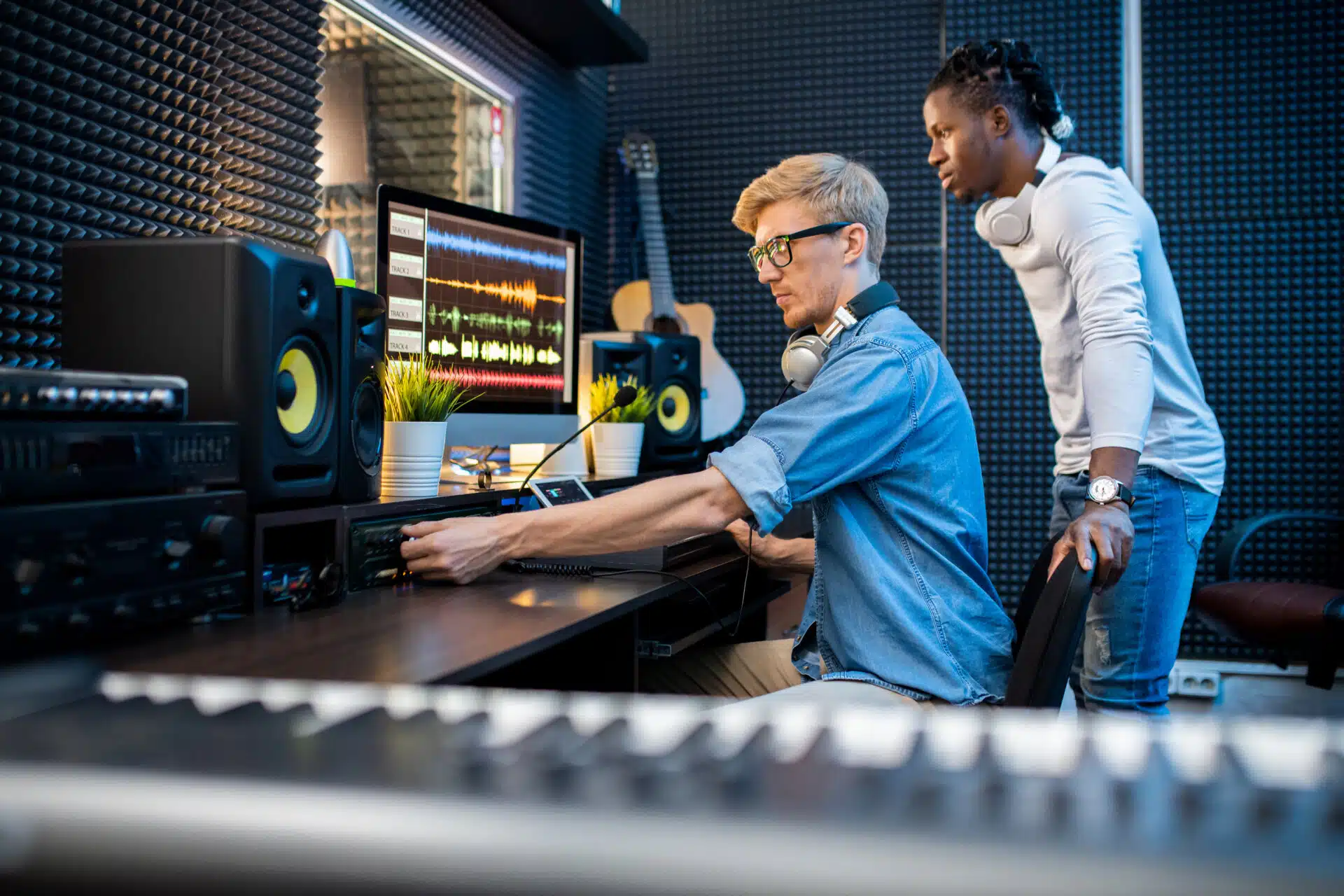 Audio engineers working at a mixer board