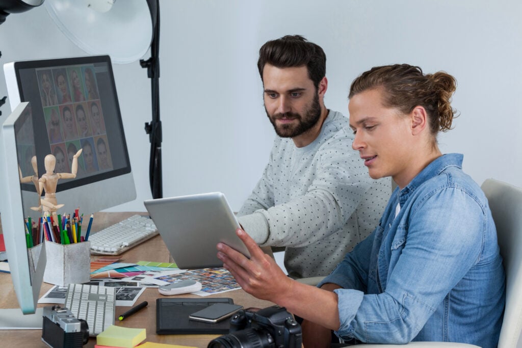 Designers critiquing portfolios.
